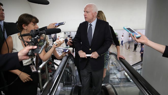 Sen. John McCain, R-Ariz., answers questions from reporters as he walks to a meeting of Republican senators July 13, 2017, in Washington, D.C. The Republican, who was diagnosed with glioblastoma on July 19,
 2017, returns to Washington on Tuesday,
 July 25, 2017. The announcement of his return seemed to provide a jolt to Republican efforts to push ahead on health-care reform.