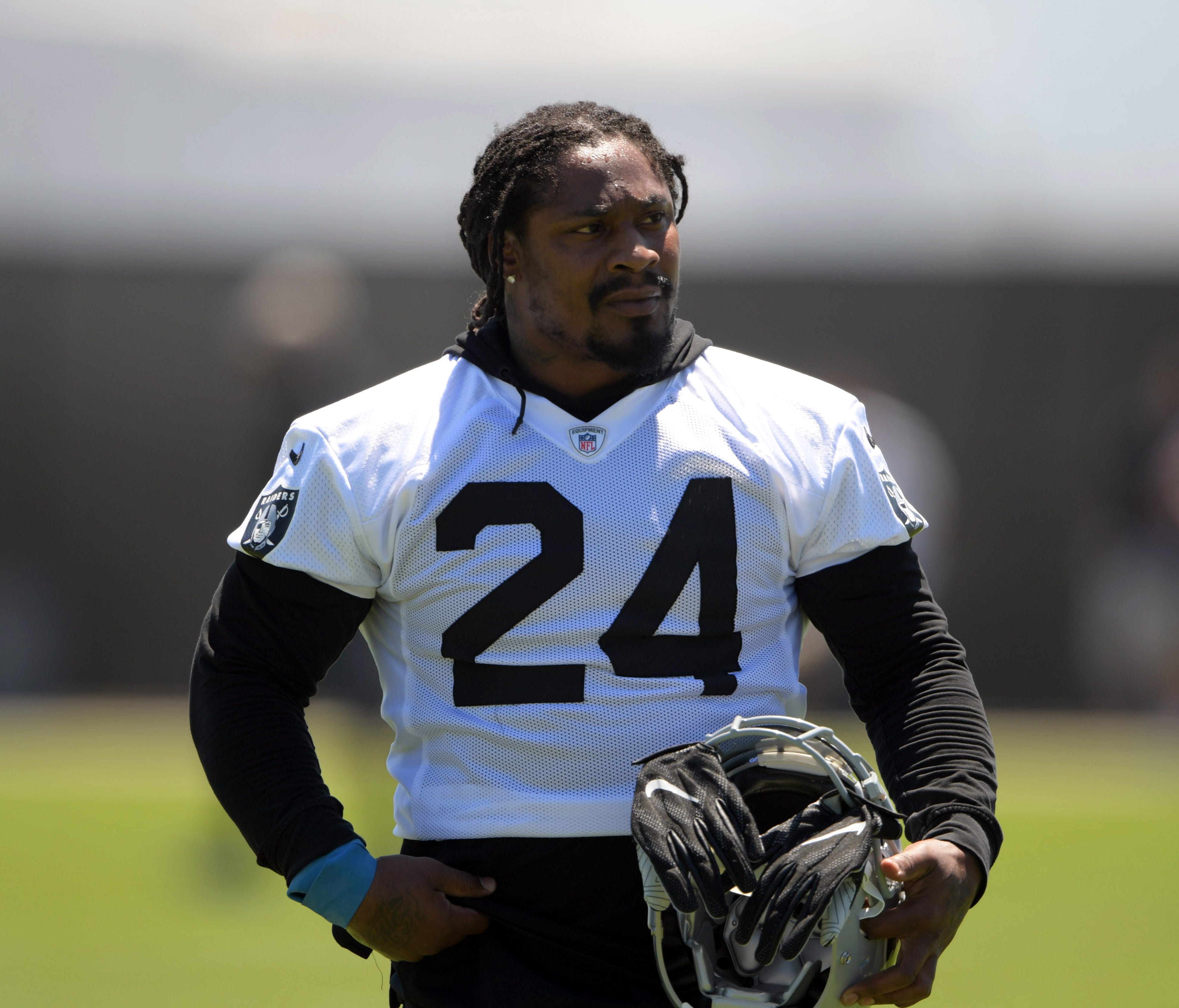 Oakland Raiders running back Marshawn Lynch (24) reacts during minicamp at the Raiders practice facility.