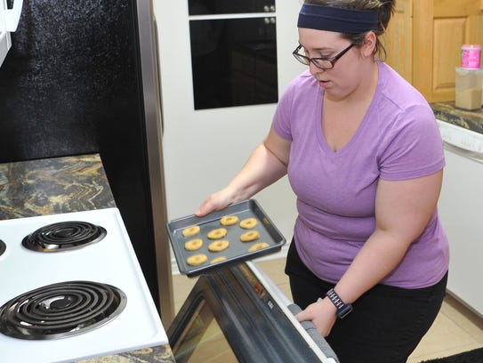 Stacey Hohertz prepares to bake gluten-free wafers.