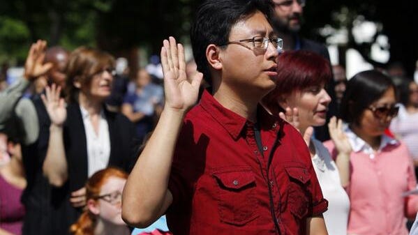 Jay Liu of Pittsford, a native of China, becomes a U.S. citizen at the annual Naturalization Ceremony in Mumford.