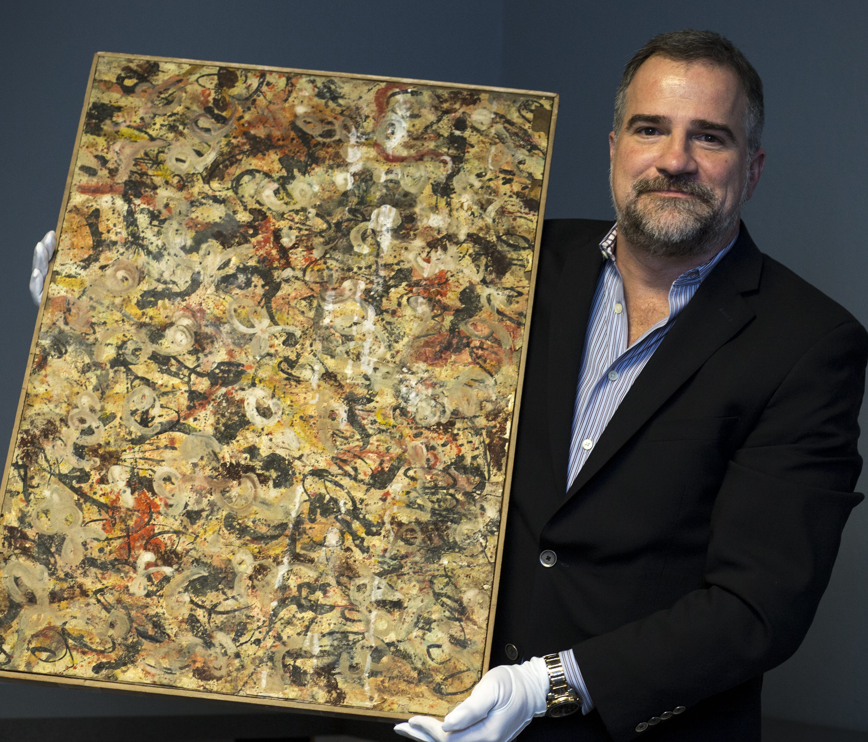 Josh Levine with an original Jackson Pollock painting, June 6, 2017, at J. Levine Auction and Appraisal, 10345 N. Scottsdale Road, Scottsdale. Levine expects the painting to sell between $10 million and $15 million.