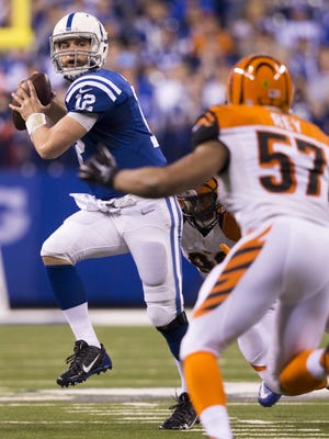 Indianapolis Colts quarterback Andrew Luck (12) throws a third quarter touchdown, Cincinnati Bengals at Indianapolis Colts, Lucas Oil Stadium, Sunday, Jan. 4, 2015.
