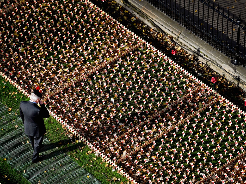 Veterans and members of the public pay tribute to those who died during war at the opening of the garden of remembrance at the Princess Street Gardens in Edinburgh, Scotland.