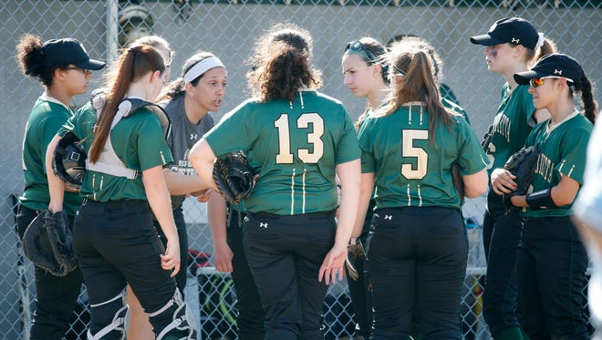 Rush-Henrietta coach Lynn Rotola (with headband) talks with her team, including junior catcher Jaimee Rodgers (wearing shinguards) during Wednesday's matchup with Victor.
