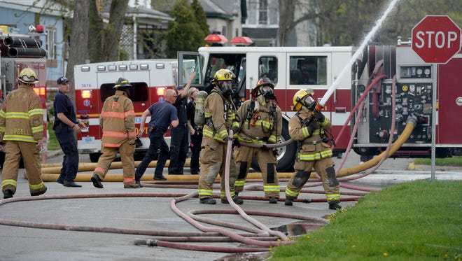 Richmond firefighters work to control a fire Friday, April 22, 2016 at N. D and 12th Streets in Richmond.