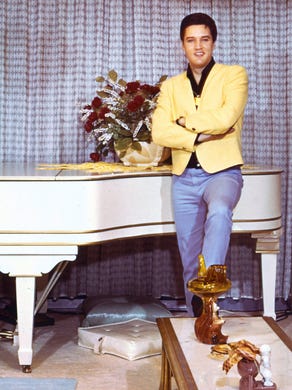 Elvis Presley at his piano inside Graceland in this