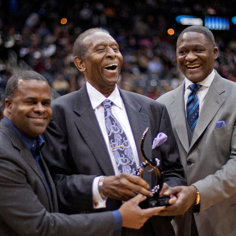Lloyd, center, is honored at an Atlanta Hawks game