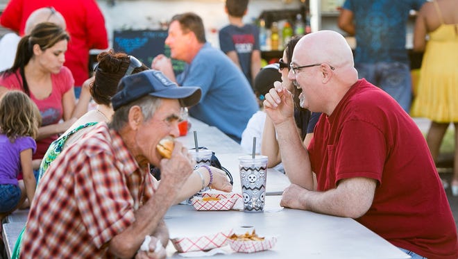 Visitors eat at Gilbert's weekly Food Truck Court.