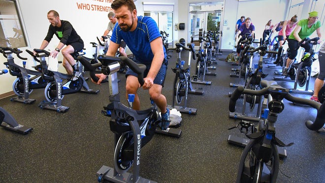 Cameron Tuckfield takes a spin class at the Cleveland St. YMCA on Tuesday, February 21, 2017. 
