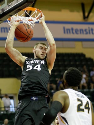 Xavier's Sean O'Mara (54) dunks the ball over Missouri's Kevin Puryear (24) during the first half of the Tire Pros Invitational NCAA college basketball game, Thursday, Nov. 17, 2016, in Kissimmee, Fla.