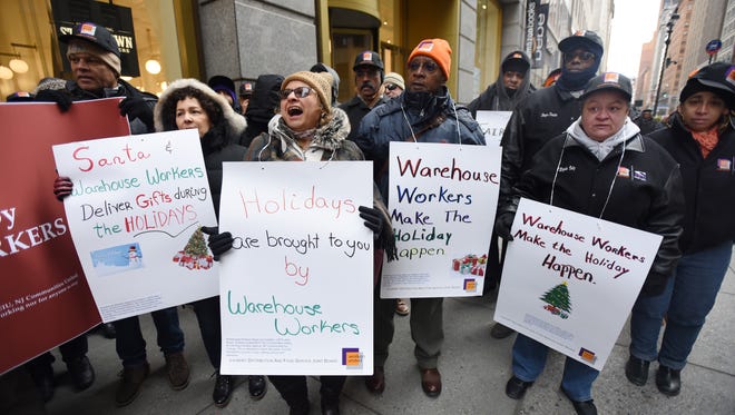 Warehouse workers including Elba Liz (2nd from L) of Brooklyn and Cathy Carrasco (3rd from L) of Queens protest outside of the Amazon Books store in New York City to urge better conditions for warehouse workers.