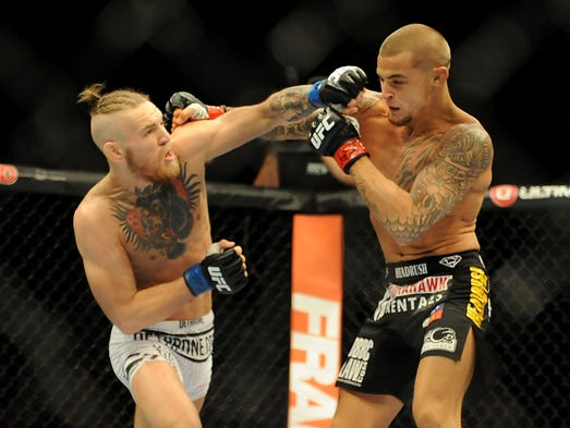 McGregor, left, throws a punch against Dustin Poirier