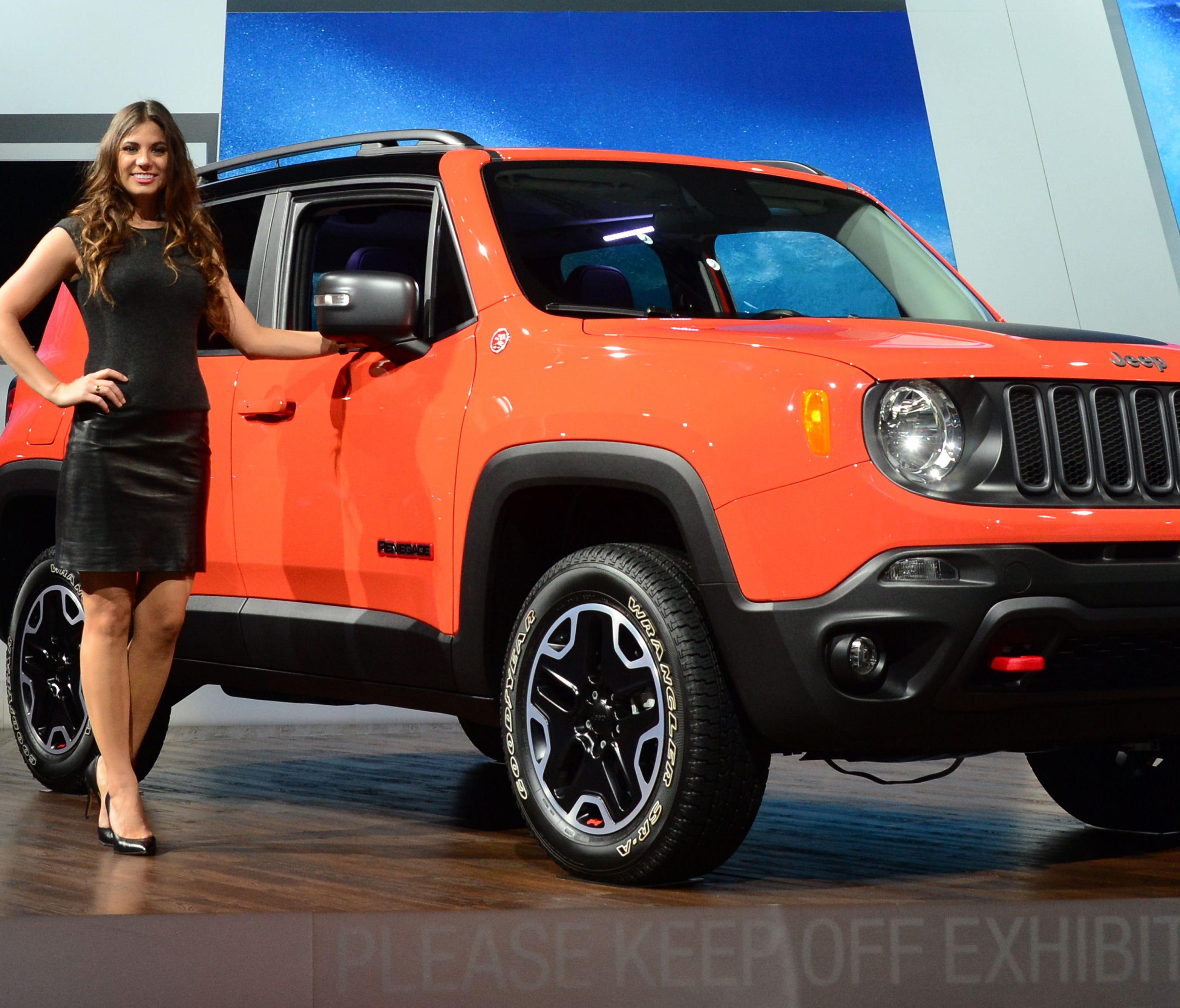 A model poses beside the Jeep Renegade on display at the Los Angeles Auto Show in 2014