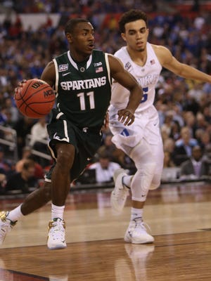 Michigan State's Tum Tum Nairn drives against the Duke Blue Devils' Tyus Jones during second half action in MSU's 81-61 loss to Duke in the Final Four on April 4, 2015, at Lucas Oil Stadium in Indianapolis.