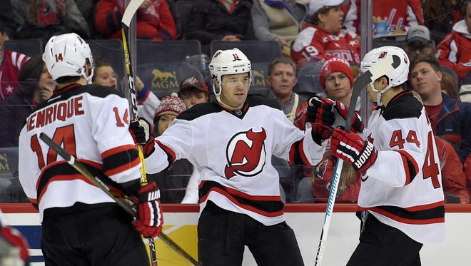 The Devils PA Parenteau (11) celebrates his goal with Miles Wood (44) and Adam Henrique (14) on Thursday, Dec. 29, 2016, in Washington. Wood got a surprise autograph from Alex Ovechkin prior to Thursday night's game that the Devils won, 2-1, in a shootout.