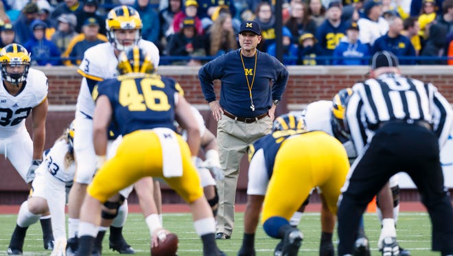 Michigan Wolverines head coach Jim Harbaugh looks on as quarterback Wilton Speight (3) gets set to run a play during the spring game at Michigan Stadium.