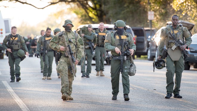 Members of the Escambia County Sheriff’s Office SWAT team leave the scene of a standoff near Avery Street and Fernwood Avenue in Pensacola on Wednesday, March 7, 2018. Authorities said the suspect barricaded himself inside a home on Avery Street and the SWAT team negotiated with him for about two hours before he was taken into custody.