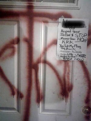 Stanley Wesley returned home Thursday night to find "KKK" spray-painted on his front door and a message tacked to the door. (Edited to obscure racial epithet.)