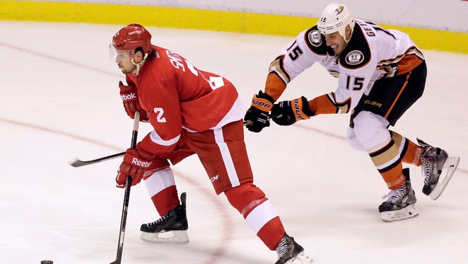 Detroit Red Wings' Brendan Smith (2) is pursued down the ice by Anaheim Ducks' Ryan Getzlaf (15) during the third period of an NHL hockey games Saturday, Oct. 11, 2014, in Detroit.