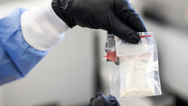 An evidence bag with heroin at the Kentucky State Police Crime Lab in Frankfort, Kentucky awaits to be examined. Employees at the lab have begun treating everything that comes in as if it contains the much more potent drug Fentanyl, which can be fatal at very small doses. Feb. 1, 2017