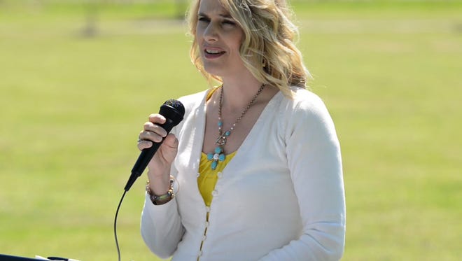 Shanna Ambrose gives the keynote speech at the National Crime Victims' Rights Week tree-planting Tuesday afternoon at Shirlene Mercer Trail Park.