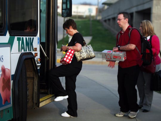 A woman boards a TANK bus. The Transit Authority of Northern Kentucky (TANK) will offer free rides to all passengers "until further notice," as communities deal with the novel coronavirus pandemic.