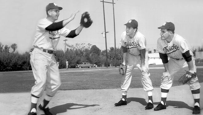March 22, 1951 - Memphis Chicks manager Luke Appling (left) gives a lesson in covering first base from the pitcher's mound to lefthander Russ Miller and righthander Dick Strahs at the club's Fort Pierce, Florida, spring training camp on March 22, 1951.