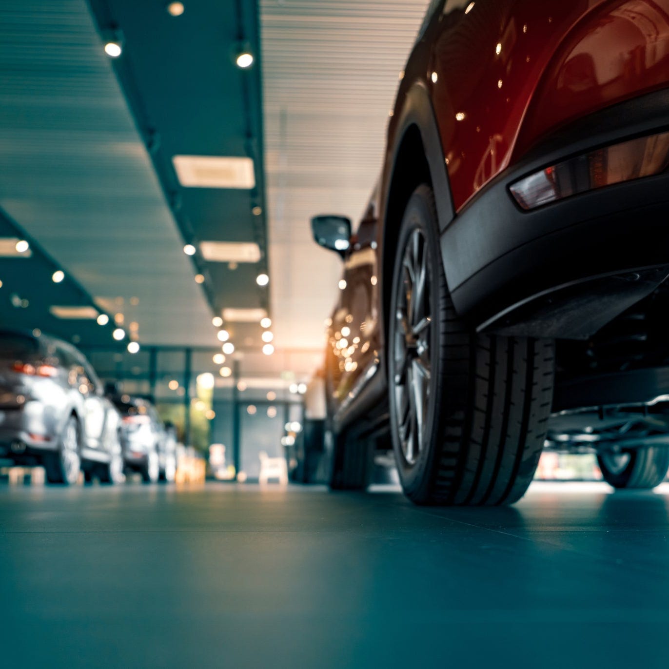 Cars inside of a dealership.