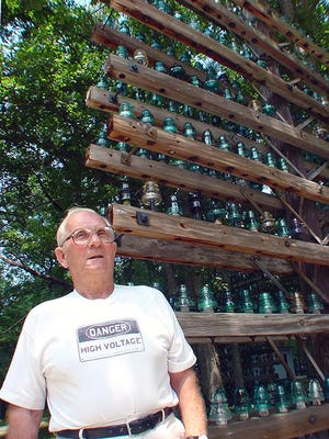 Stanley Hammell by his collection of telegraph insulators.
