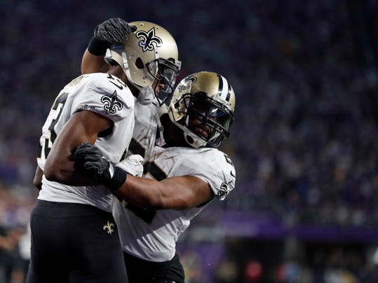 New Orleans Saints wide receiver Michael Thomas (13) celebrates his touchdown with running back Mark Ingram (22) during the second half of an NFL divisional football playoff game against the Minnesota Vikings in Minneapolis, Sunday, Jan. 14, 2018. (AP Photo/Jeff Roberson)