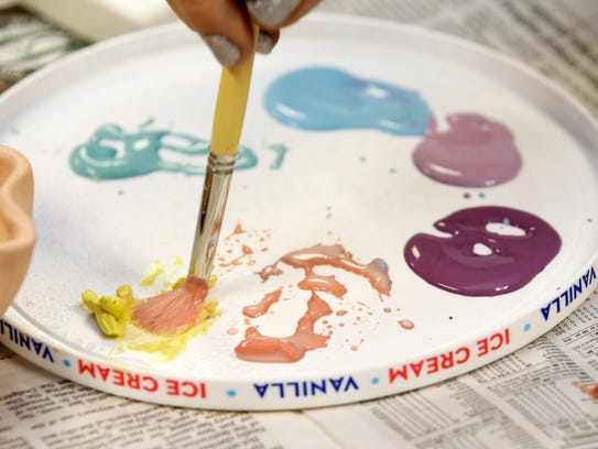 Glazing colors during a ceramics class at WHAM Community