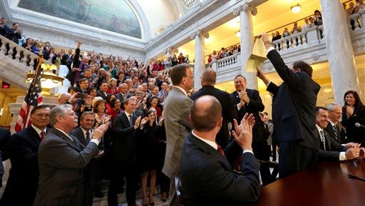 FILE - In this March 12, 2015, file photo, Utah Gov. Gary Herbert stands after signing an anti-discrimination bill at the Capitol in Salt Lake City. A Mormon church-backed anti-discrimination law that protects gay and transgender people and religious rights took effect Tuesday, May 12, 2015, amid skepticism from LGBT residents over whether the legislation really lives up to its reputation. (Laura Seitz/The Deseret News via AP, File)