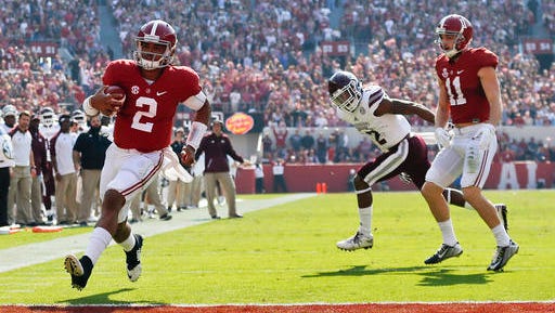 Alabama quarterback Jalen Hurts, left, scores a touchdown during the first half of an NCAA college football game against Mississippi State, Saturday, Nov. 12, 2016, in Tuscaloosa, Ala.