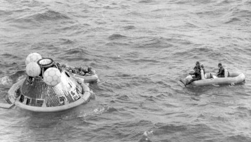 FILE - In this July 24, 1969 file photo, the Apollo 11 command module lands in the Pacific Ocean and the crew waits to be picked up by U.S. Navy personnel after an eight day mission to the moon. The Apollo 11 command module, which travelled more than 950,000 miles to take Americans to the moon and back in 1969, is going on a road trip, leaving the Smithsonian for the first time in more than four decades.
