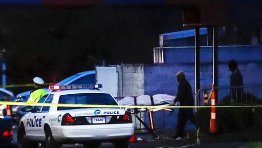 A body is removed as police work at the Cameo club after a fatal shooting, Sunday, March 26, 2017, in Cincinnati.