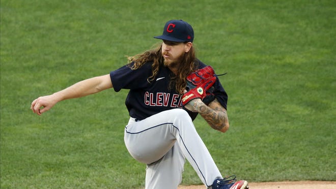 Cleveland Indians' pitcher Mike Clevinger throws against the Minnesota Twins in a baseball game Friday, July 31, 2020, in Minneapolis.