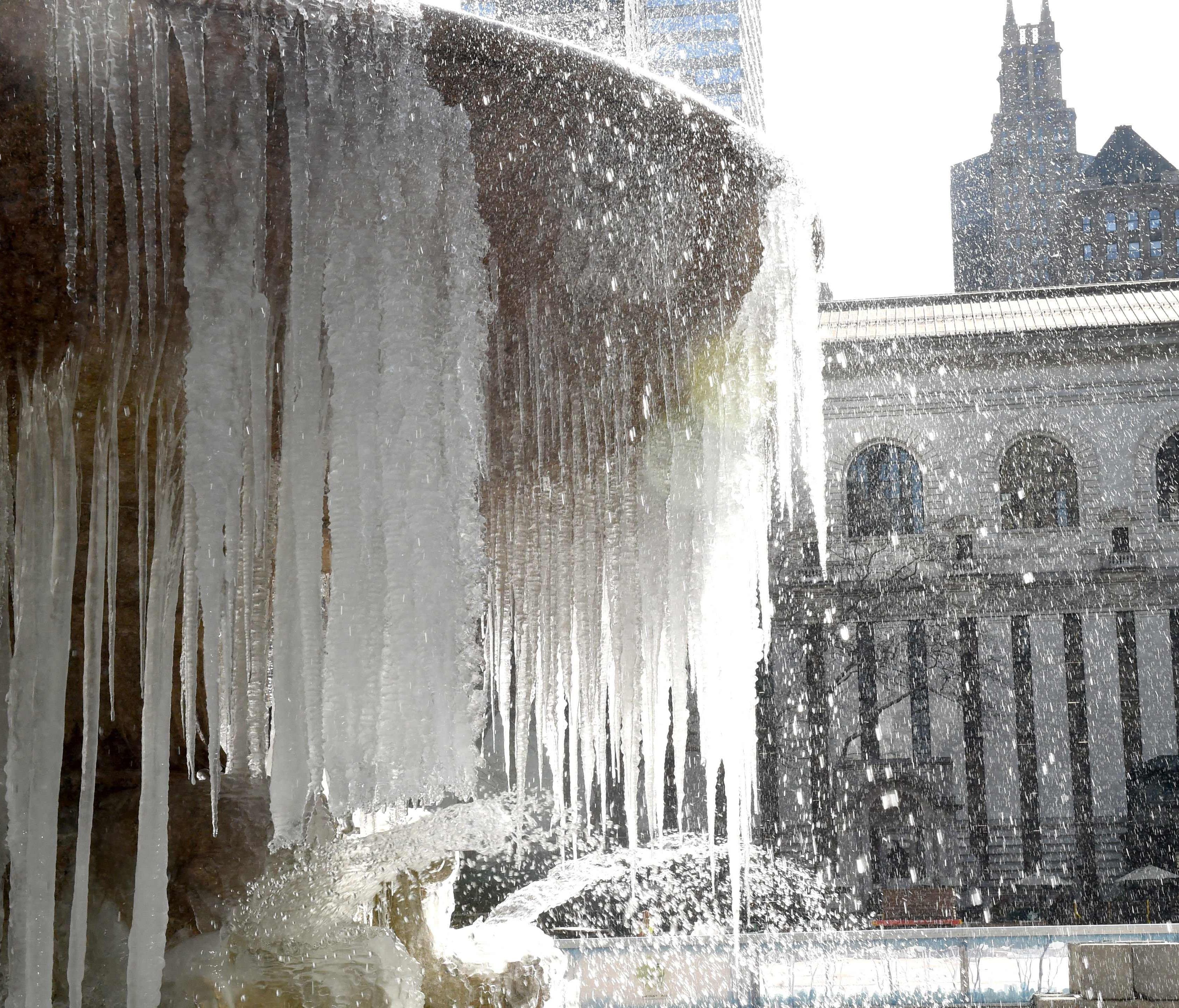 The Josephine Shaw Lowell Memorial Fountain in Bryant Park is covered in ice and snow as Winter Storm Stella pounds the East Coast.