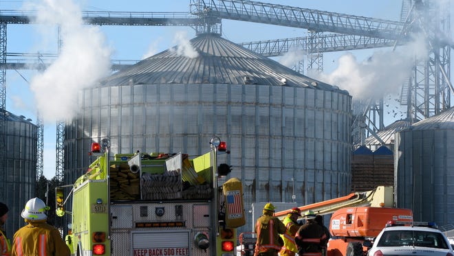 Smoke pours from holes in a grain bin in Brokaw after an
explosion in January 2011.
