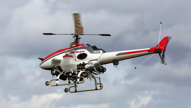 The Yamaha RMax unmanned helicopter takes flight during a demonstration of its aerial application capabilities at the University of California-Davis' Oakville Station test vineyard in Oakville, Calif., on Oct. 15, 2014.