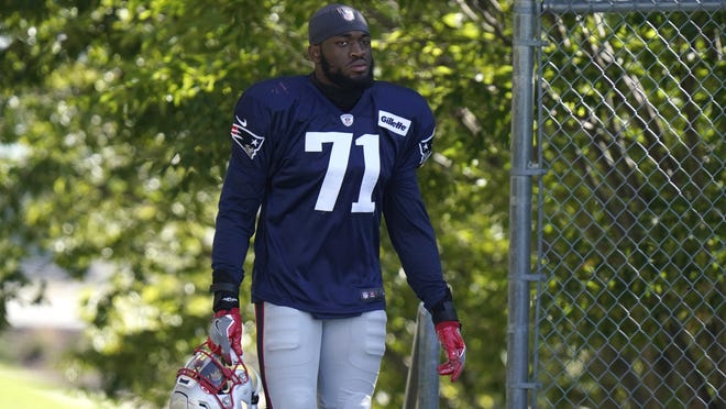 New England Patriots linebacker Josh Uche steps on the field at the start of an NFL football training camp practice, Tuesday, Aug. 18, 2020, in Foxborough, Mass.