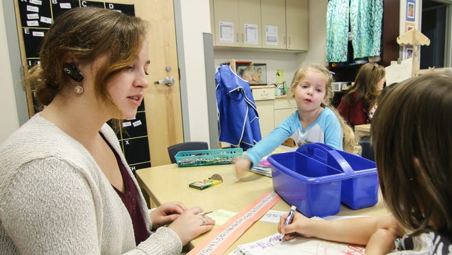 Student teacher Charlotte Christie, left, wears a wireless headset to communicate with Master Teacher while teaching a class Thursday, Nov. 05, 2015 at UD Laboratory Preschool in Newark.