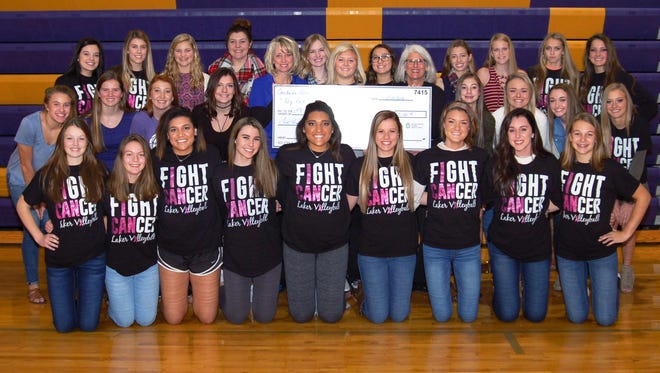 Members of the Camdenton R-III high school volleyball teams and their head coach, Austin Walker (pictured center), present a $5,200 donation to Lake Regional Cancer Center Director Marcy Maxwell and Lake Regional Fund Development Director Terri Hall.