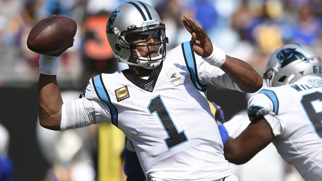 In this Sept. 9, 2019, file photo, former Panthers quarterback Cam Newton looks for a receiver during the second half of the their game against the Los Angeles Rams. The Patriots have reached an agreement with free-agent quarterback Newton, bringing in the 2015 NFL Most Valuable Player to help the team move on from three-time MVP Tom Brady.