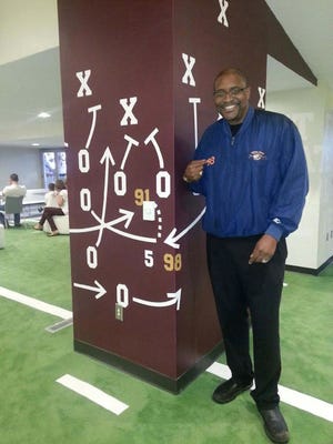 Former Mississippi State and Chicago Bears player Tyrone Keys stands beside a display of the defensive play that saved MSU’s 6-3 win over Alabama in 1980.