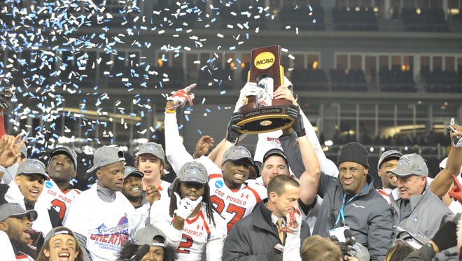 CSU_Pueblo players and coaches celebrate after winning the 2014 NCAA Division II championship, the fourth national football title won by a Colorado school over the past 26 years.