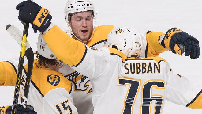 Nashville Predators' Craig Smith (15) celebrates with teammates P.K. Subban (76) and Colton Sissons (10) after scoring against the Montreal Canadiens during second-period NHL hockey action in Montreal Saturday.