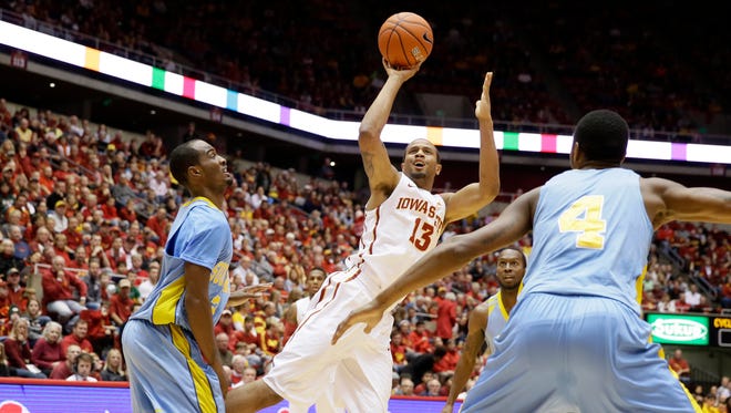 Iowa State guard Bryce Dejean-Jones, center, shoots between Southern University's Adrian Rodgers, left, and Keith Davis, right, during the first half of an NCAA college basketball game, Sunday, Dec. 14, 2014, in Ames, Iowa.