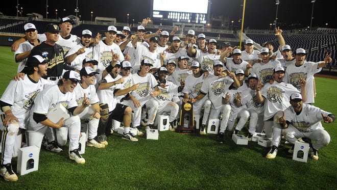 Vanderbilt coaches and players pose for a team photo in the outfield at TD Ameritrade Park after winning the College World Series on Wednesday night.