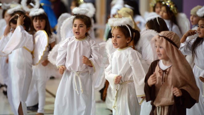 Kindergarten students dressed as angels and shepherds dance during the Christmas Program for grades kindergarten through second Tuesday afternoon, Dec. 13, 2016 at St. Mary's Central Catholic School in Odessa, Texas. The program told the story of the birth of Jesus along with seasonal songs. (AP Photo/Odessa American, Mark Sterkel)