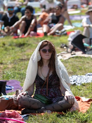 Sarah Stewart, 29, sits in the grass Saturday, Aug.